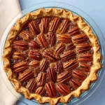 Delicious slice of the best pecan pie with a golden crust and rich filling