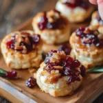Deliciously baked cranberry brie bites served on a plate.