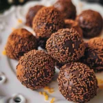 Delicious homemade Orange Chocolate Christmas Truffles on a festive plate.