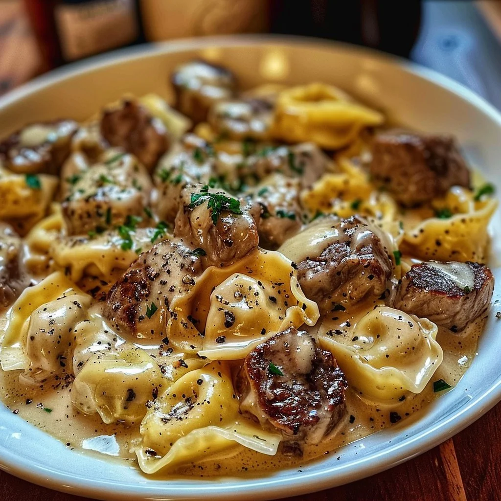 Delicious Cracked Garlic Steak Tortellini served in a bowl with herbs