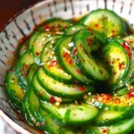 Spicy Asian Spiral Cucumber Salad topped with sesame and chili flakes