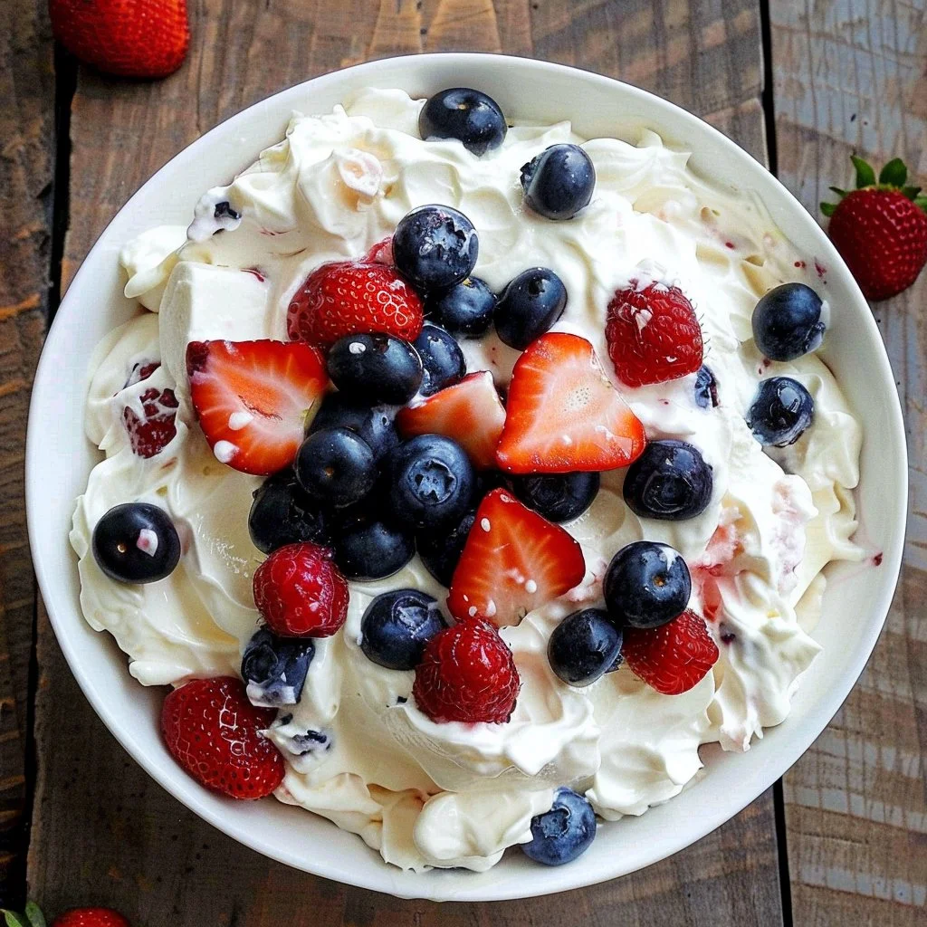 Easy cheesecake salad with blueberries and strawberries in a bowl