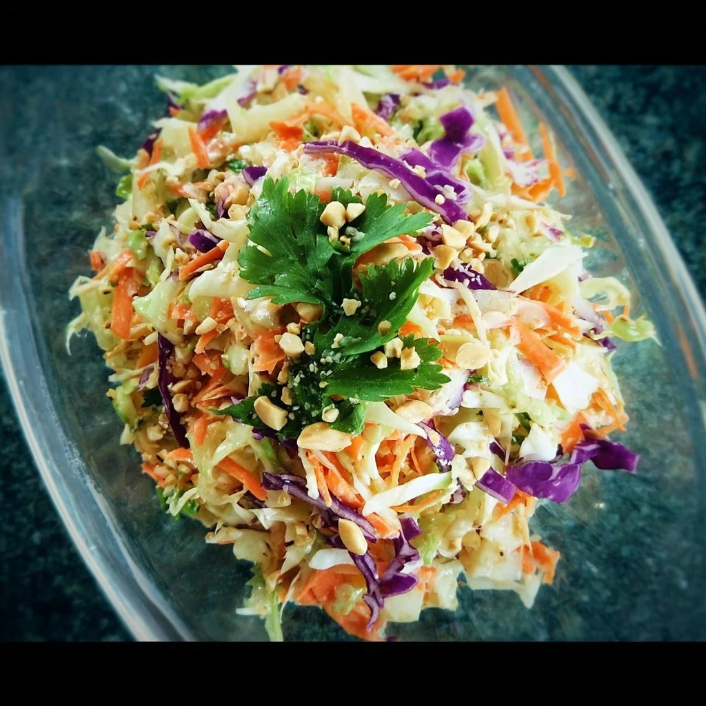 Colorful Asian Slaw Salad with fresh vegetables and sesame dressing on a plate.