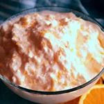 Bowl of Keto Orange Creamsicle Fluff Salad topped with fresh orange slices