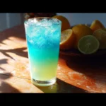 A vibrant glass of mermaid lemonade with colorful hues and garnishes
