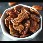 Bowl of quick and easy caramel pecans with a shiny caramel glaze