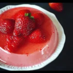 Sugar-free strawberry jello salad served in a bowl with fresh strawberries