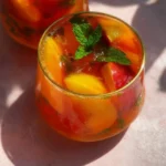 Delicious Peach Sangria garnished with fresh fruit, perfect for summer sipping.