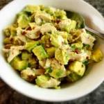Healthy avocado chicken salad recipe with chicken, avocado, and fresh ingredients.