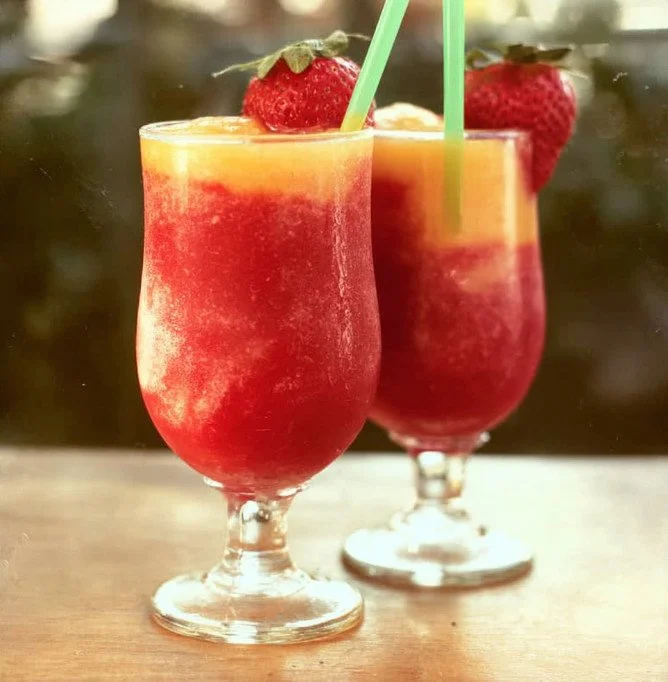 Refreshing Strawberry and Peach Wine Slushies in a glass, perfect for summer.